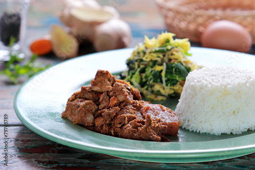 beef rendang served with urap and rice