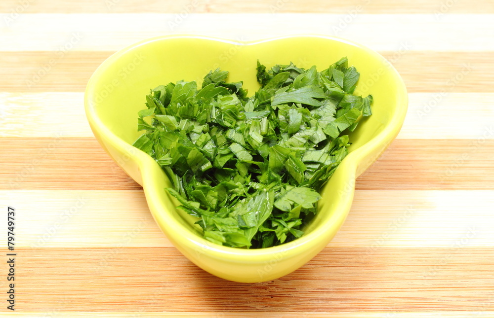 Fresh and natural chopped parsley in yellow dish Fresh and natural chopped parsley in yellow dish