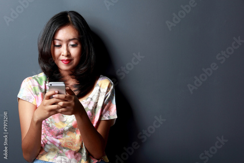 young woman enjoy playing gadget