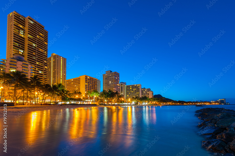 Tall buildings on Waikiki reflect in the water