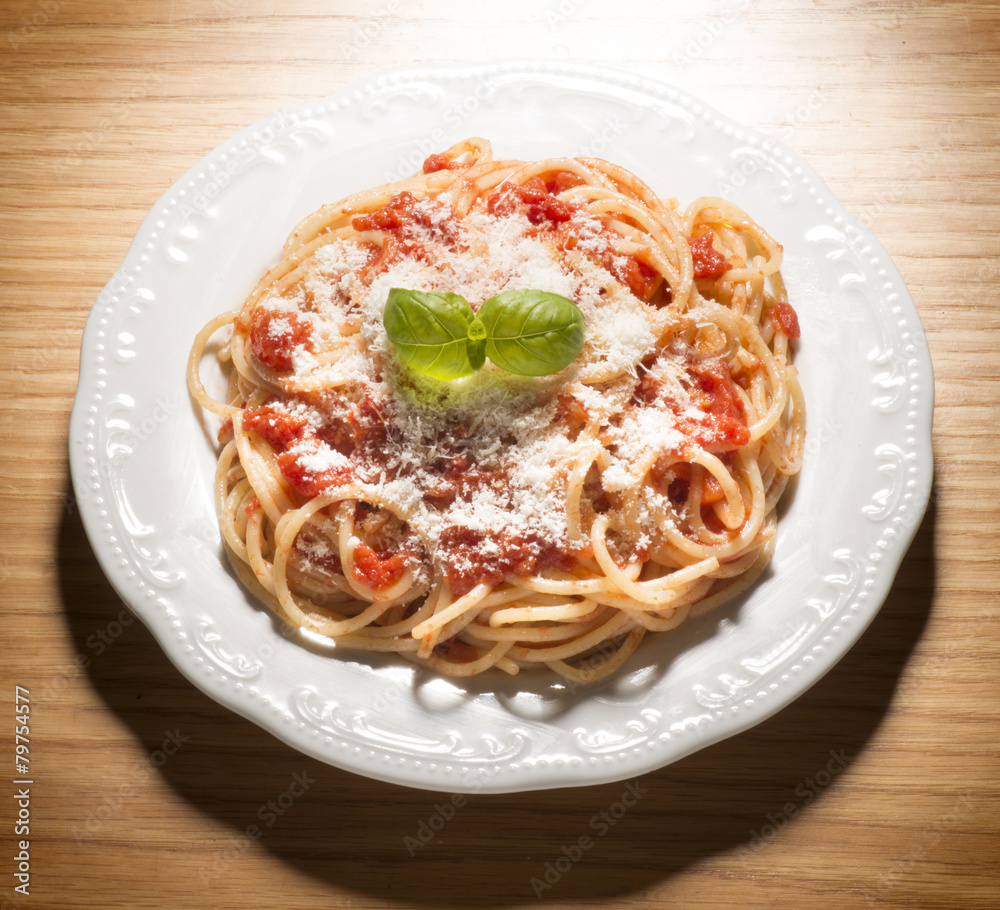 Fototapeta premium dish with spaghetti and tomato sauce on the wooden table