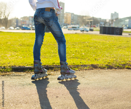 A beautiful caucasian roller skater woman during the sunset, out