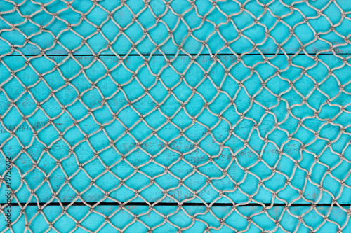 Blank antique teal blue sign with fish net overlay