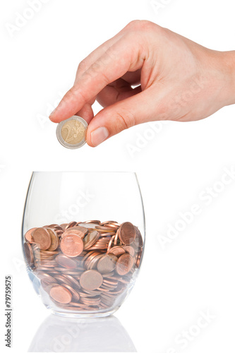 Hand with 2 euro coin and glass with euro cents