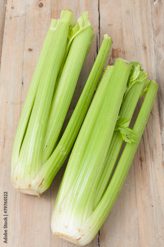 organic celery stalks on wooden background