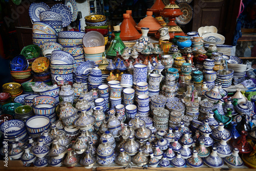 Colorful faience pottery dishes and tajines on display in Morocc © Alexmar