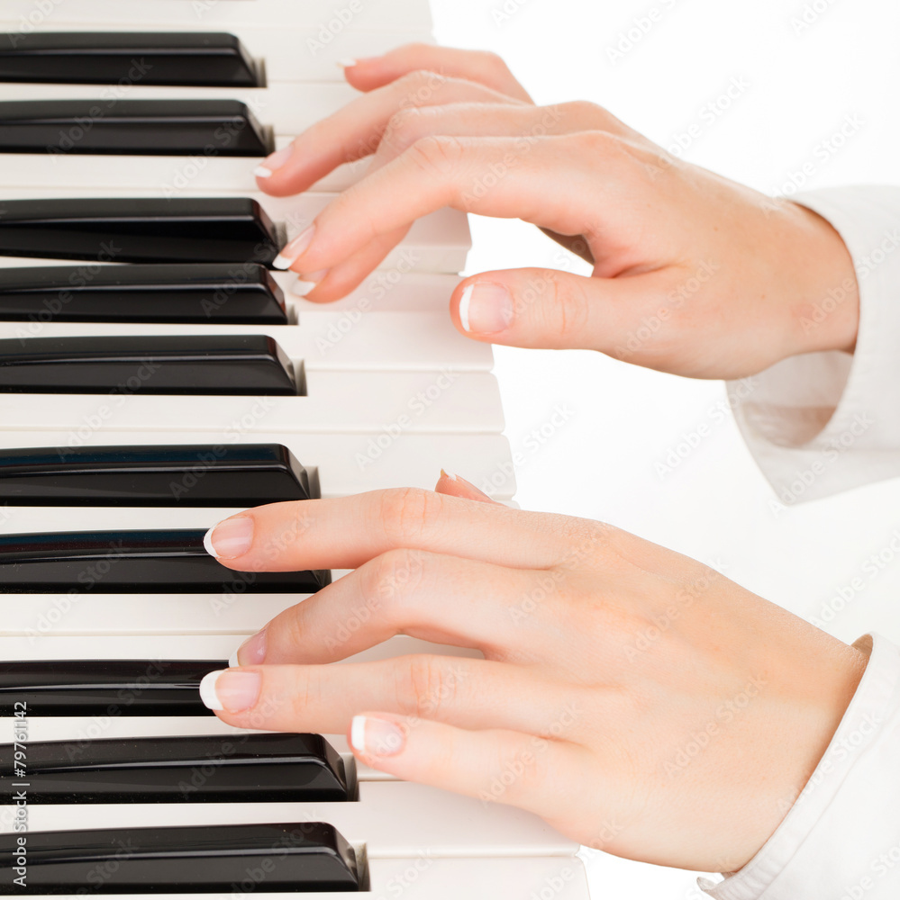 young hands of woman playing synthesizer isolated on white young hands of woman playing synthesizer isolated on white