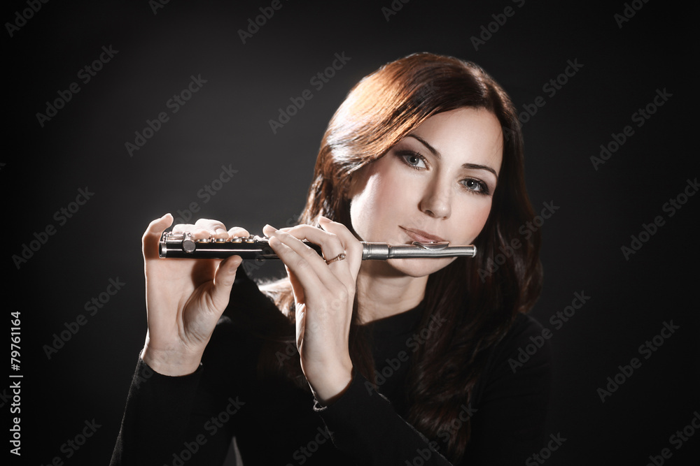 Flute piccolo flutist playing flute music instrument Photos | Adobe Stock