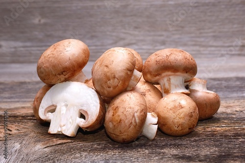 Brown champignon on wooden background