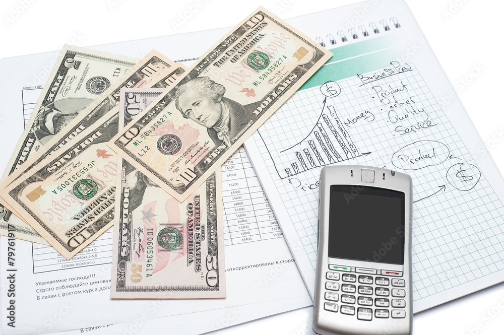 Cellphone and money on a notepad. Background image for finance Cellphone and money on a notepad. Background image for finance
