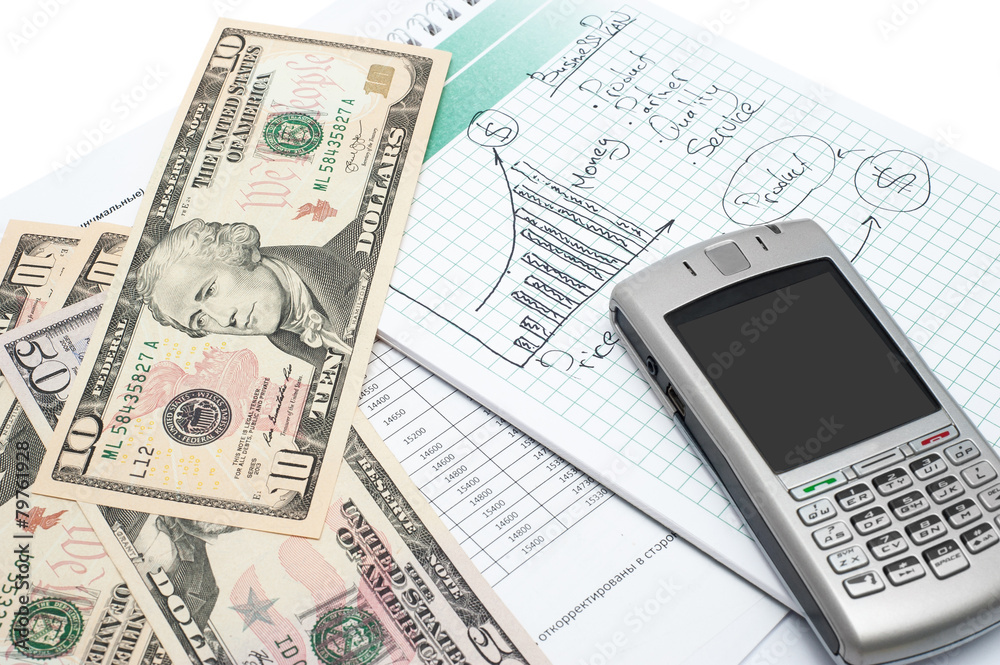 Cellphone and money on a notepad. Background image for finance Cellphone and money on a notepad. Background image for finance