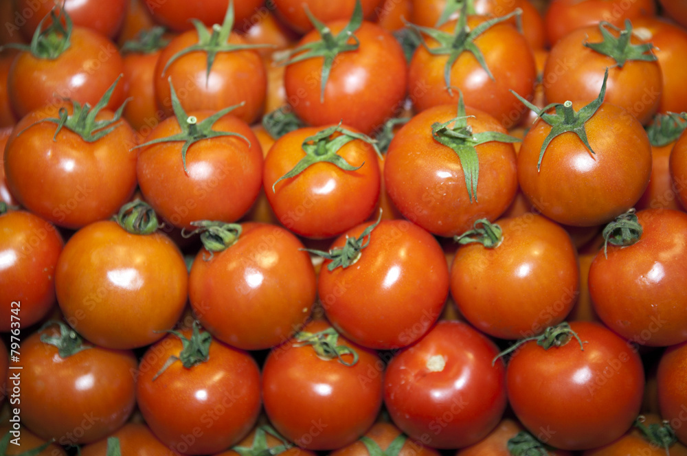 Group Of Fresh Tomatoes Background. Red Tomatoes On A Market Clo Group Of Fresh Tomatoes Background. Red Tomatoes On A Market Clo