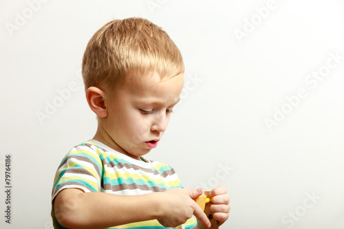 Little boy child playing with building blocks toys interior.