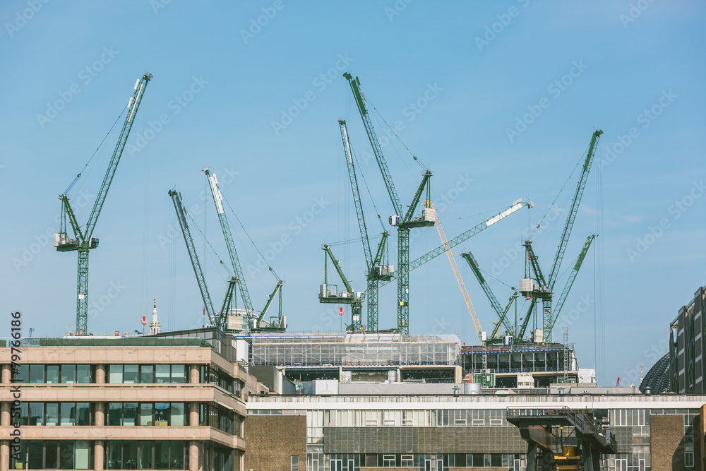 Cranes on a building site in London next to Thames