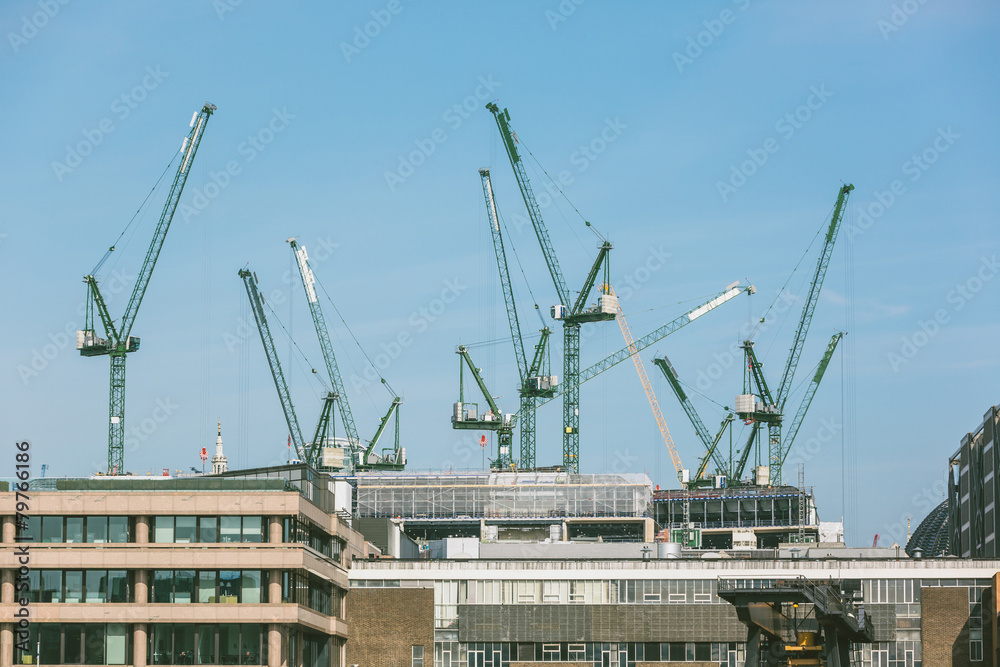 Obraz premium Cranes on a building site in London next to Thames