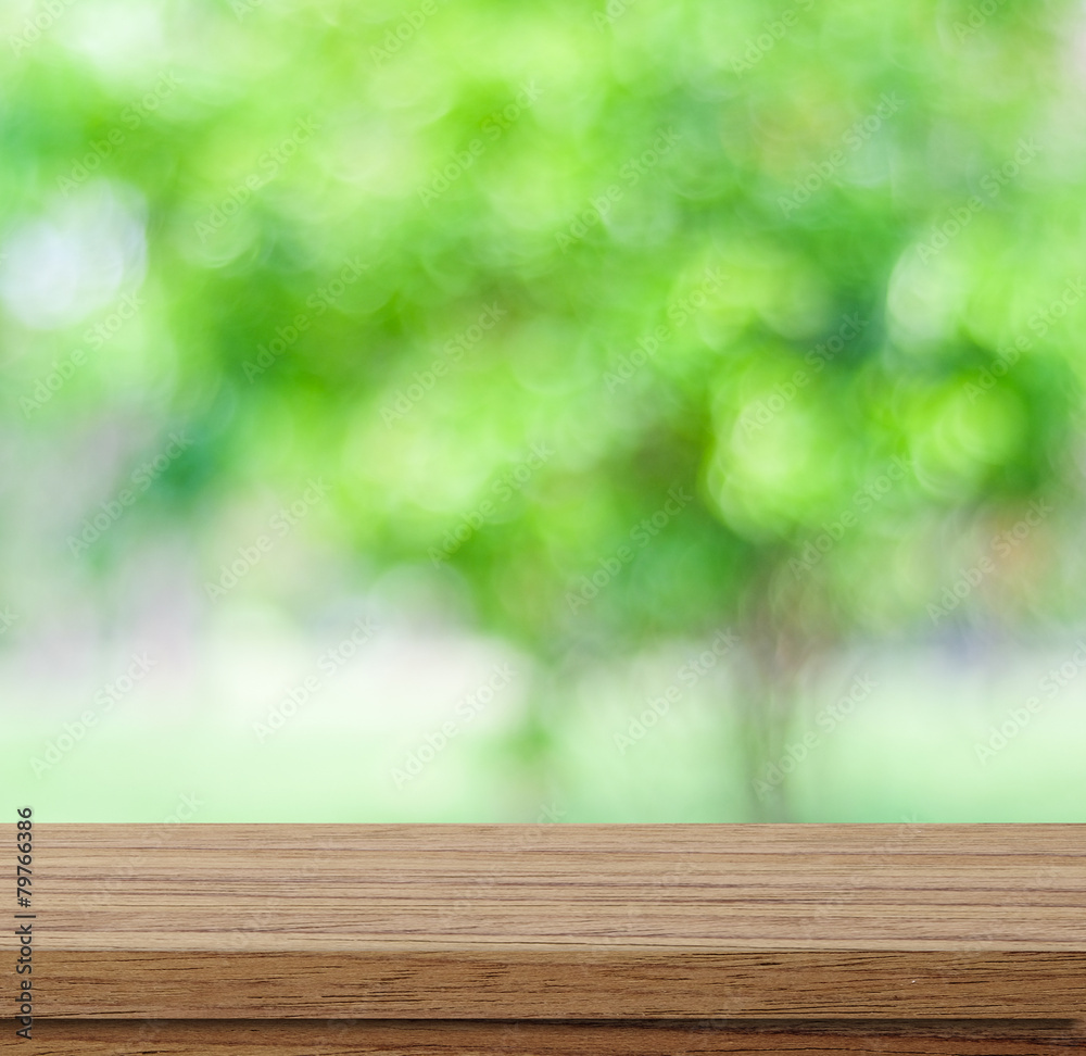 Empty wood table over blurred trees with bokeh background Empty wood table over blurred trees with bokeh background