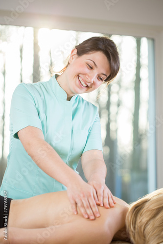 Smiling female masseur