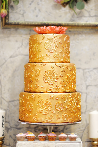 Sweet table with big golden cake