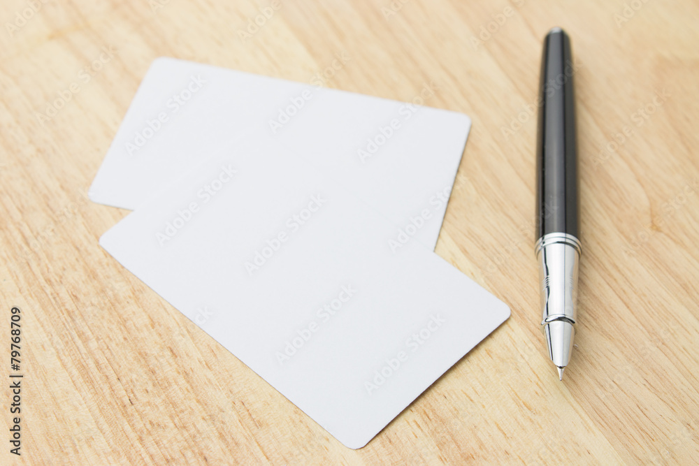 Blank business card and pen on a desk
