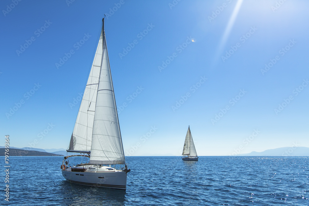 Sailing. Yachting. Ship yachts with white sails in the open sea.