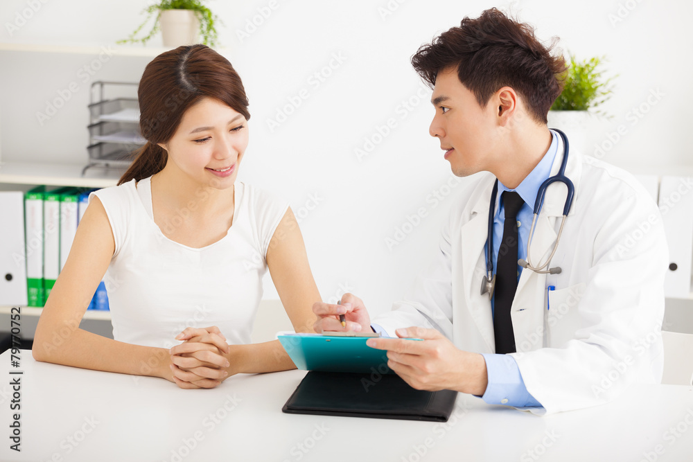 asian doctor talking with female patient in office asian doctor talking with female patient in office