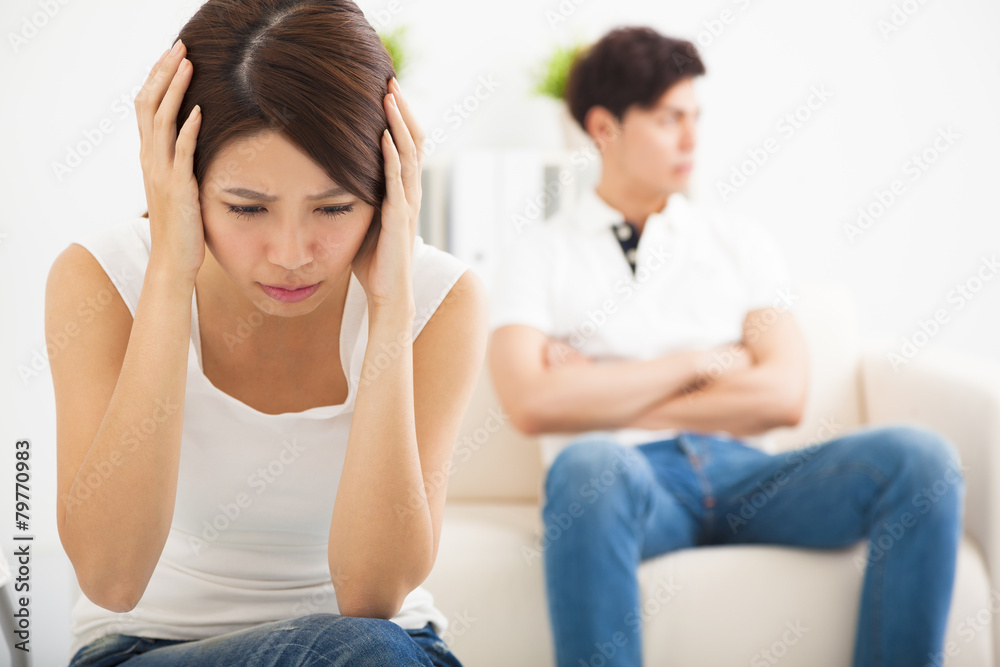 young Couple not talking after fight in living room young Couple not talking after fight in living room