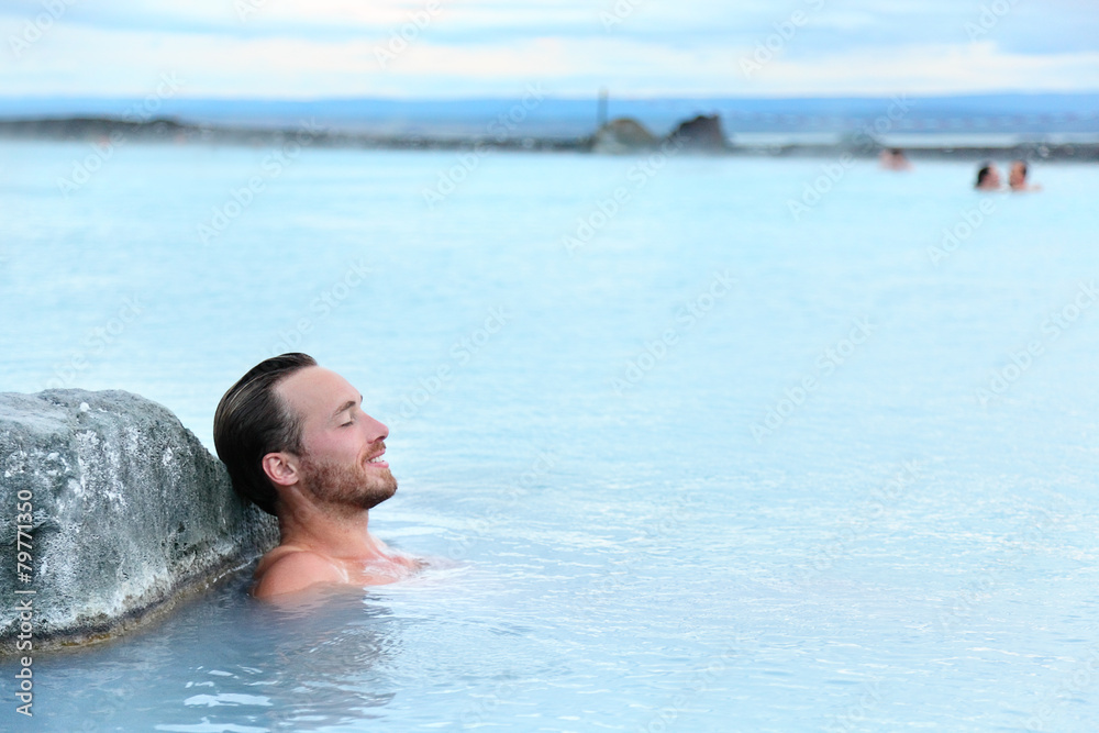 Geothermal spa - man relaxing in hot spring pool Geothermal spa - man relaxing in hot spring pool