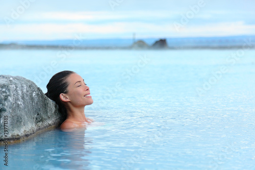 Geothermal spa - woman relaxing in hot spring pool