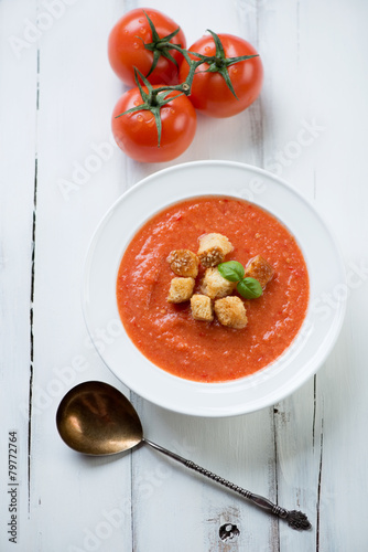 Gazpacho with croutons in a glass plate, view from above