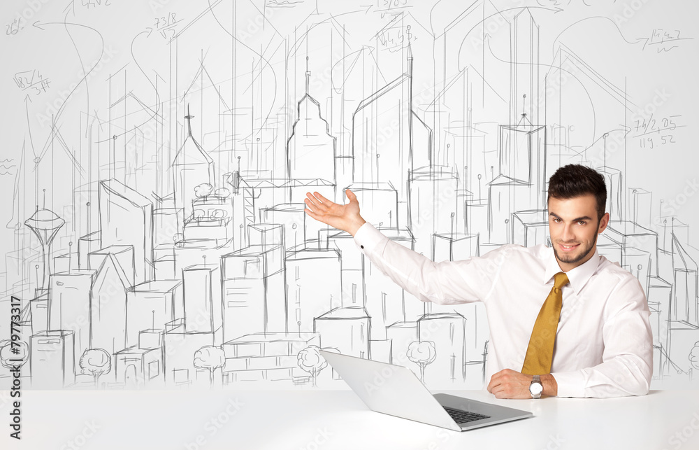 Businessman sitting at the white table with hand drawn buildings Businessman sitting at the white table with hand drawn buildings