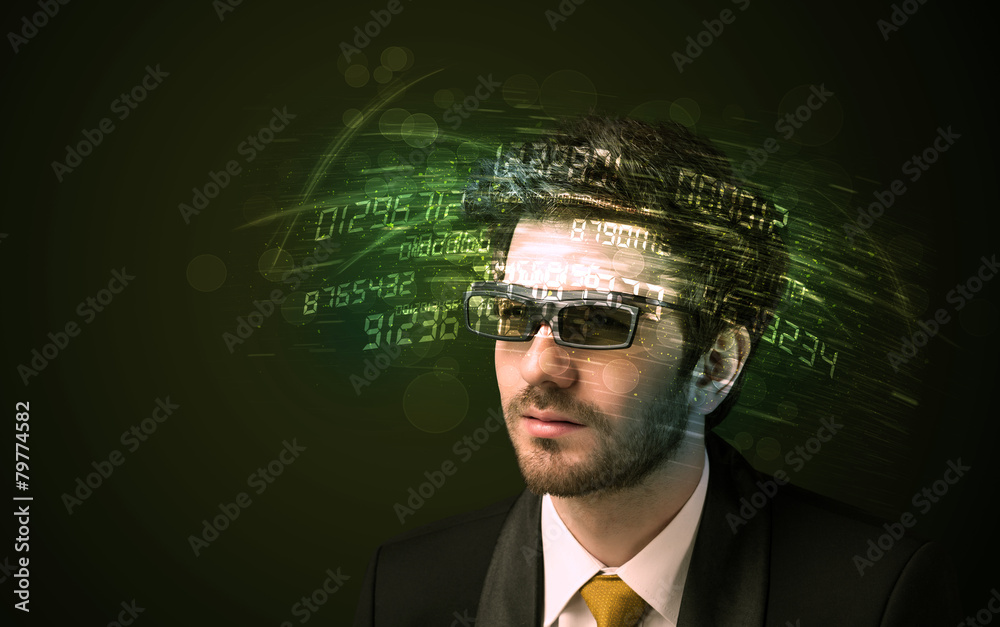 Business man looking at high tech number calculations Business man looking at high tech number calculations