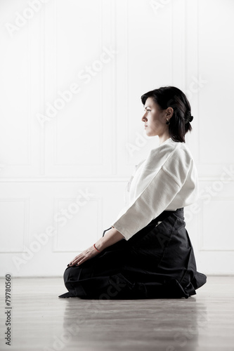 beautiful, young woman meditating in a sports hall 3
