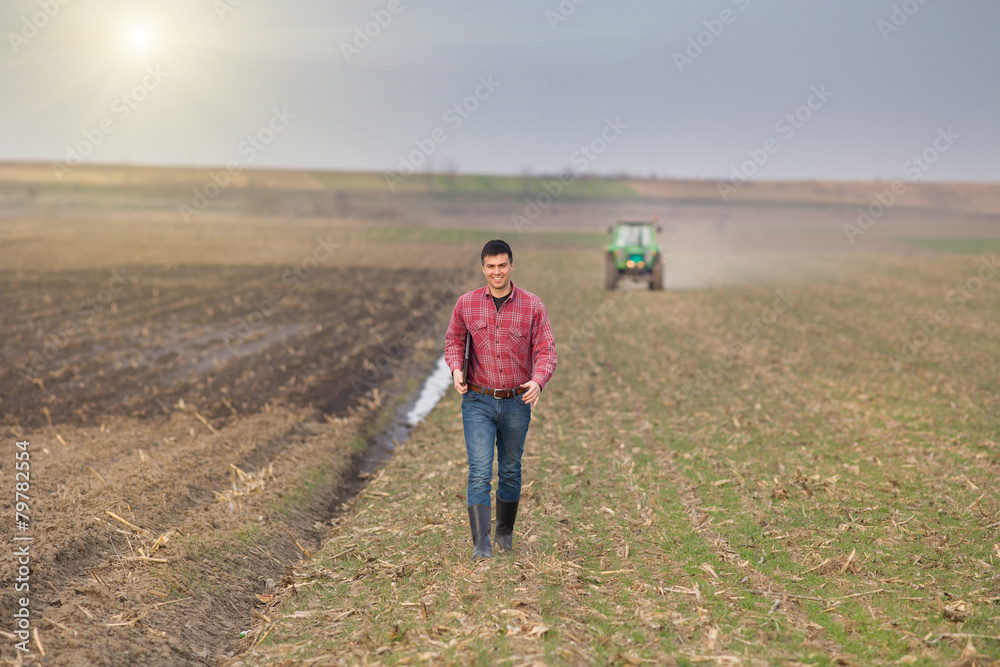 Farmer with laptop and tractor