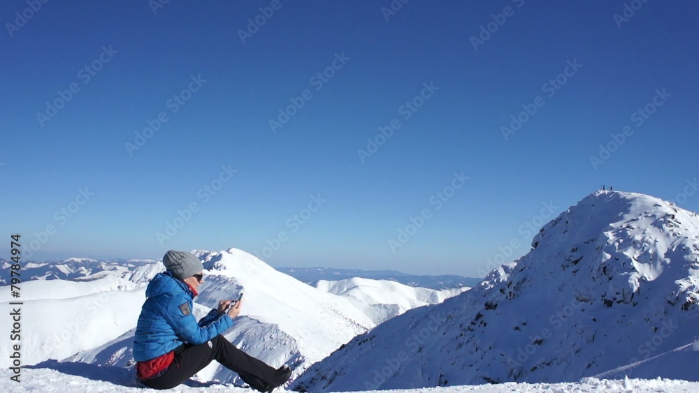 Attractive woman texting with her phone in the mountains