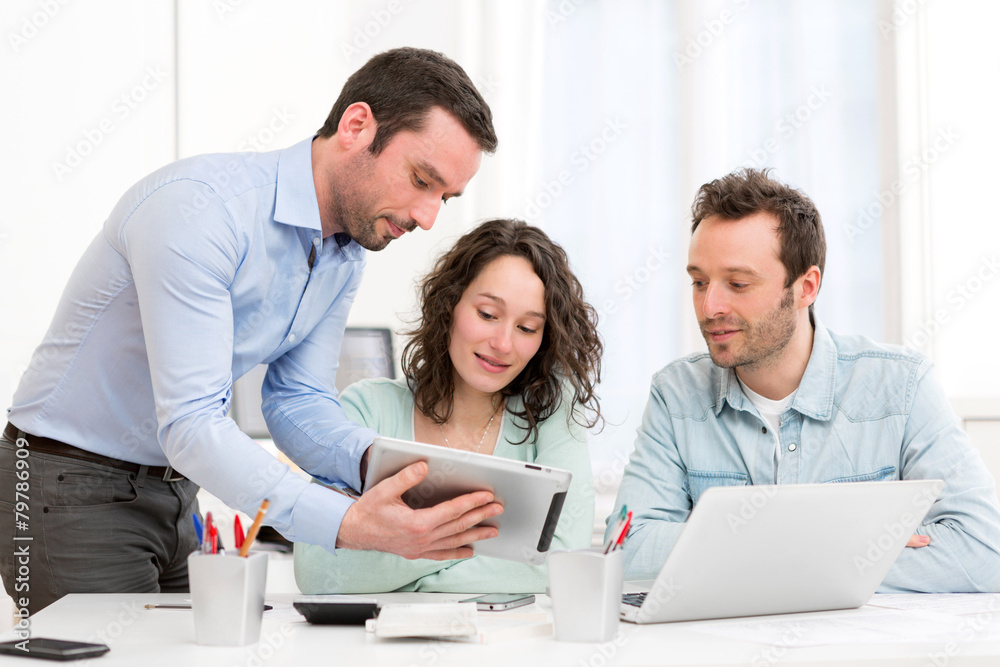 Two interns working together assisted by their course supervisor