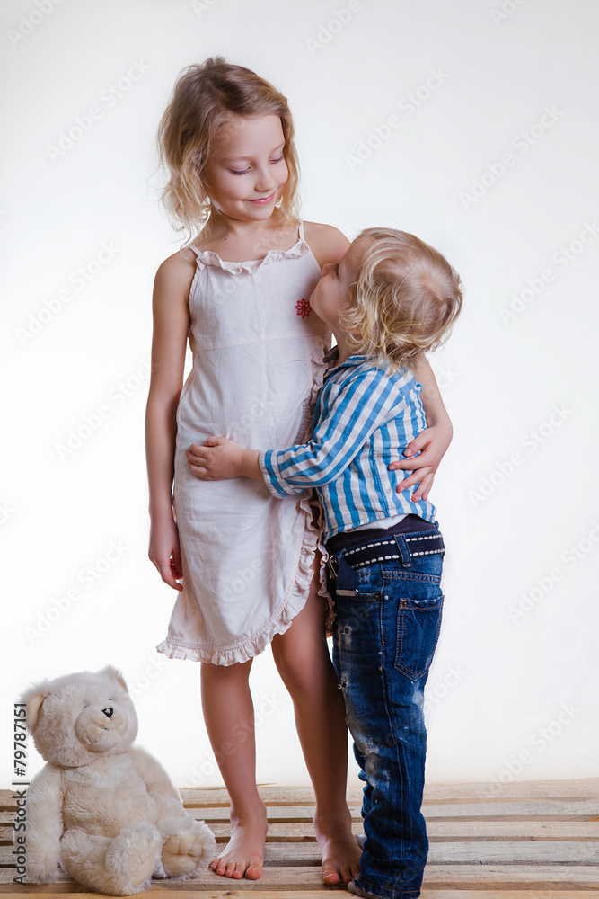 Little brother and sister playing together in a bright room Stock Photo ...