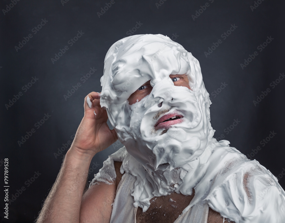 Crazy man with face completely in shaving foam Crazy man with face completely in shaving foam