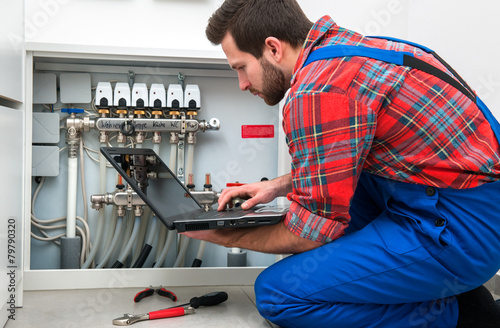 Technician servicing the underfloor heating photo