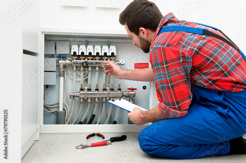 Technician servicing the underfloor heating photo