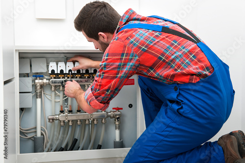 Technician servicing the underfloor heating photo