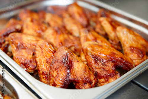 Grilled chicken wings in stainless steel container