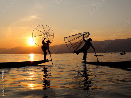 sunset and fishermen at inle lake photo