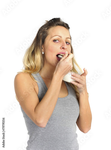 attractive girl with spoon eating cream yogurt healthy diet