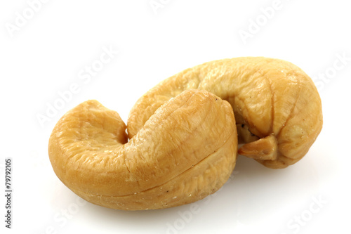 two cashew nuts on a white background