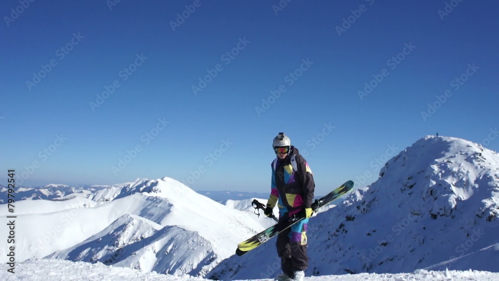 Man with skis standing on top of snowy mountain Man with skis standing on top of snowy mountain