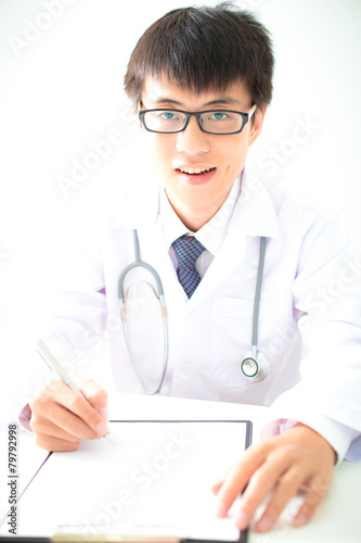 Close-up Of Male Doctor Filling The Medical Form