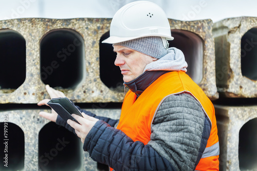 Civil engineer with tablet PC checking construction panels