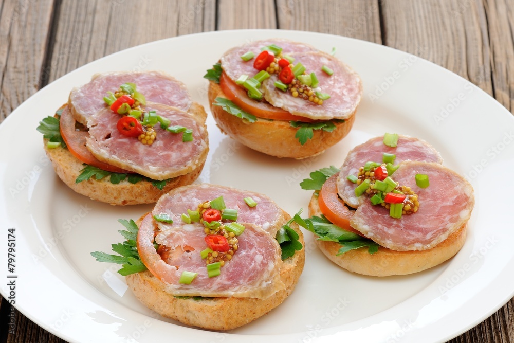Ham sandwiches with chili, parsley and scallion on white plate