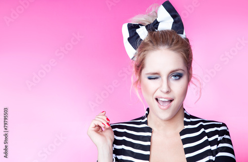 Excited winking young attractive woman