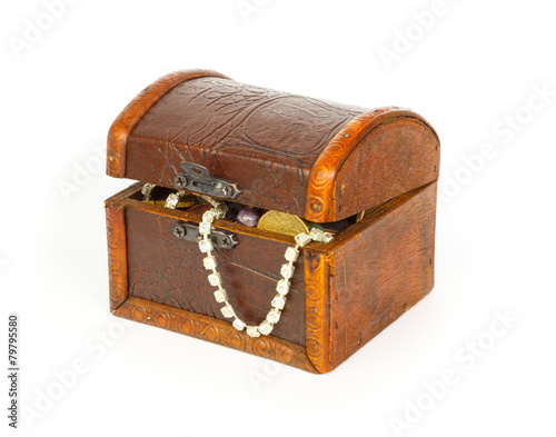 Closed treasure chest with bracelet, coins and pearls